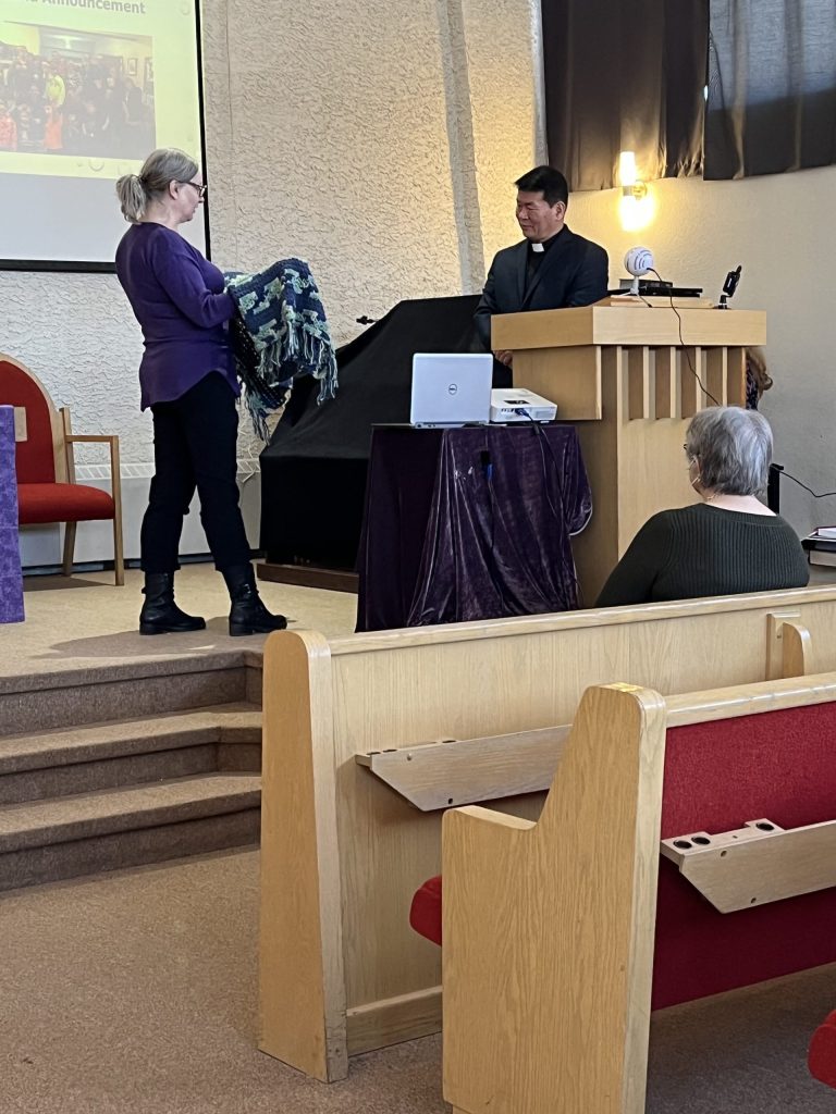 Alison presenting Sungsoon with prayer shawl